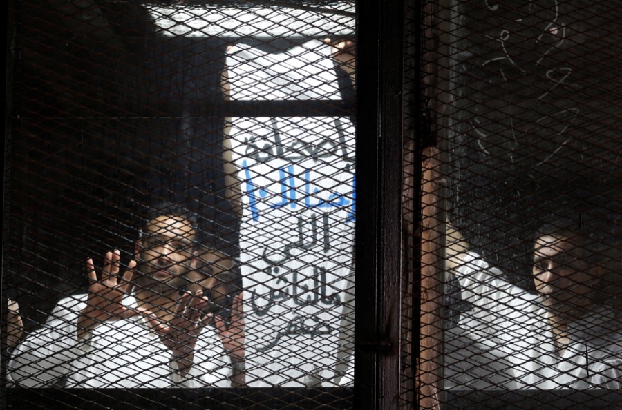 Egyptian journalists behind bars during a court trial outside Cairo Egyptian journalists behind bars during a court trial outside Cairo